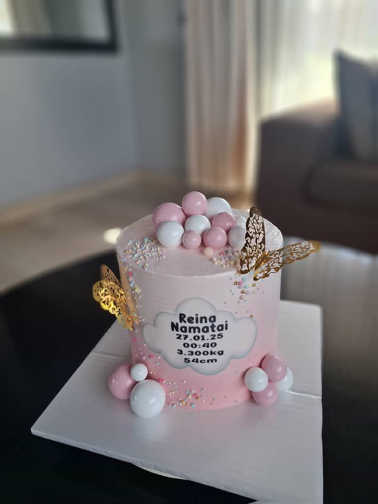 Pink baby celebration cake with gold butterflies